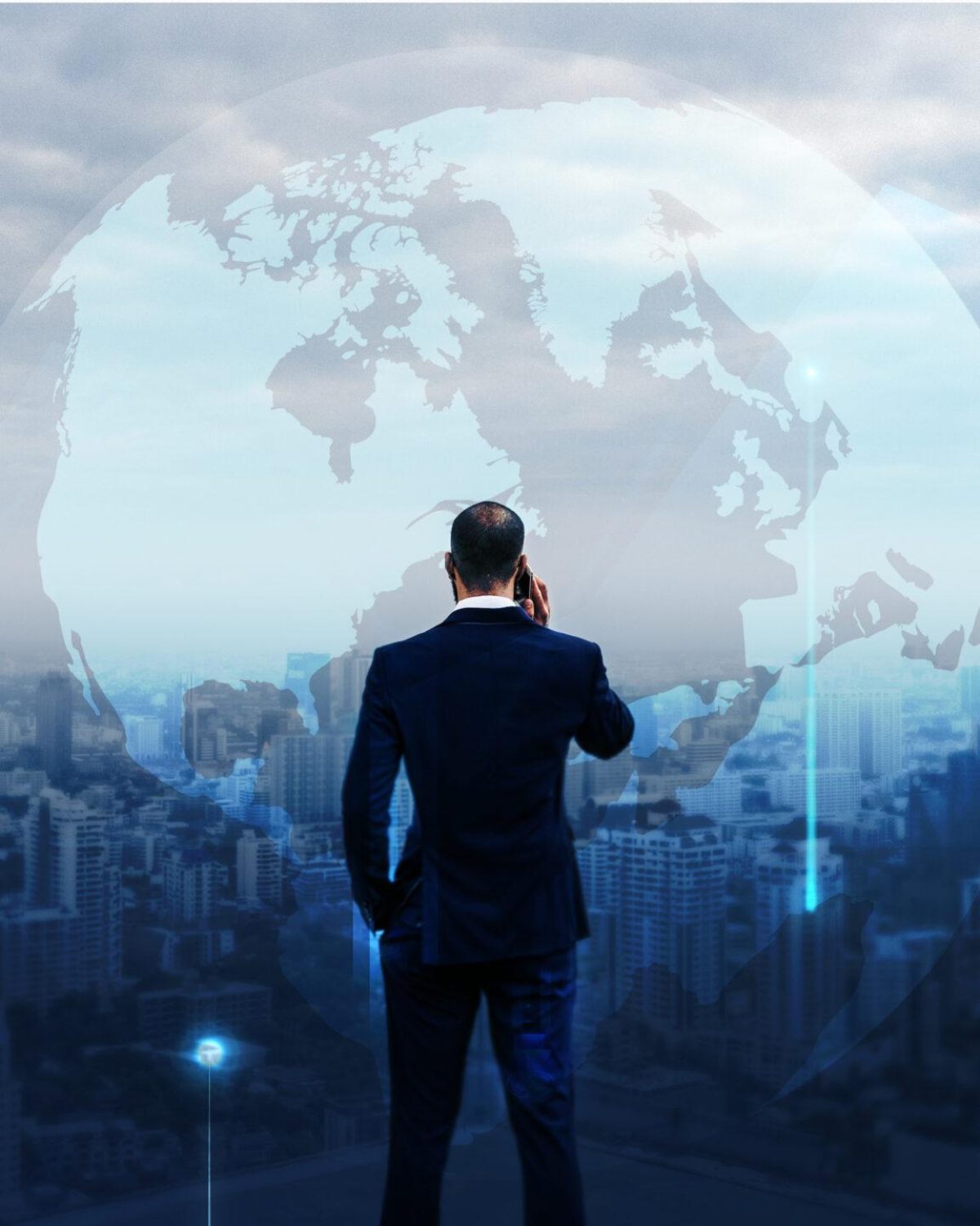 Businessman standing by on a rooftop overlooking the city